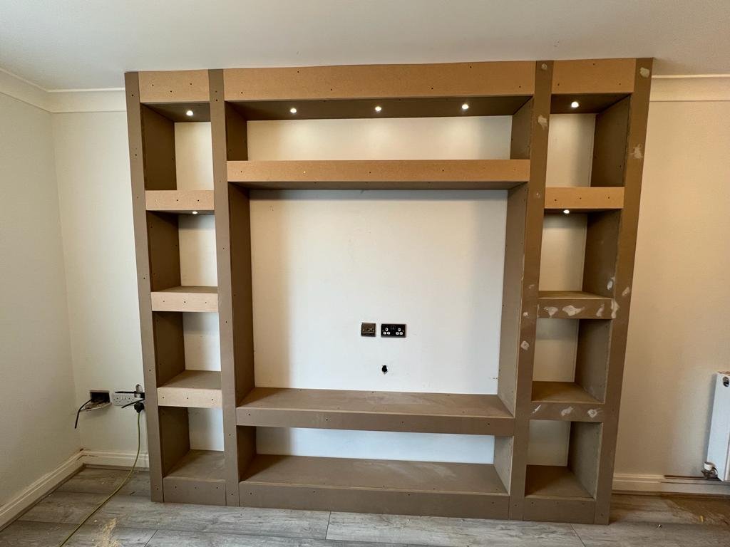 Bespoke timber media wall and shelving before painting